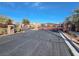 Wide angle view of gated entrance to community with desert landscaping and blue skies at 10556 Nantucket Ridge Ave, Las Vegas, NV 89166