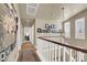 Hallway with light-colored walls, wood floors, and a chandelier hanging from the ceiling at 10556 Nantucket Ridge Ave, Las Vegas, NV 89166