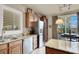 Well-lit kitchen featuring granite countertops, stainless steel appliances, and wood cabinets at 10556 Nantucket Ridge Ave, Las Vegas, NV 89166