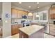 Open kitchen featuring a kitchen island, stainless steel appliances, and natural wood cabinetry at 10556 Nantucket Ridge Ave, Las Vegas, NV 89166