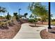 Scenic park view with paved walking paths, mature trees, and green spaces for recreation and relaxation at 10556 Nantucket Ridge Ave, Las Vegas, NV 89166