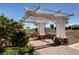 Charming pergola with bench seating and stone accents, offering a relaxing spot with mountain views at 10556 Nantucket Ridge Ave, Las Vegas, NV 89166