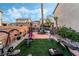 Backyard with turf, brick patio, and exercise equipment, creating an inviting space for outdoor activities at 1071 Nordyke Ave, Henderson, NV 89015