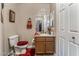 Small bathroom with red accents and a brown cabinet sink at 1071 Nordyke Ave, Henderson, NV 89015