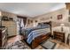 Bedroom with a wooden bed and a dark striped comforter at 1071 Nordyke Ave, Henderson, NV 89015