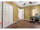 This bedroom offers neutral walls, carpeted floors, a ceiling fan, and ample closet space at 1071 Nordyke Ave, Henderson, NV 89015