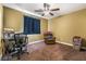 This bedroom features neutral walls, a ceiling fan, and carpeted floors, ideal for a home office or guest room at 1071 Nordyke Ave, Henderson, NV 89015