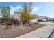 Attractive home with desert landscaping and a spacious driveway and sidewalk at 1071 Nordyke Ave, Henderson, NV 89015