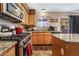 Modern kitchen featuring granite countertops, stainless steel appliances, and tile floors at 1071 Nordyke Ave, Henderson, NV 89015