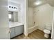 Bathroom includes a white shower-tub combo, toilet, sink, and vanity at 1150 N Buffalo Dr # 1005, Las Vegas, NV 89128