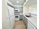 Kitchen showcasing stainless steel sink, white appliances, and gray cabinets at 1150 N Buffalo Dr # 1005, Las Vegas, NV 89128