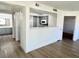 Open floor plan of living room with view into kitchen and hall to the bath at 1150 N Buffalo Dr # 1005, Las Vegas, NV 89128