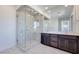 Bathroom boasts a glass shower and modern double vanity at 1320 Crimson Sunbird Ave, North Las Vegas, NV 89084