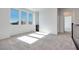 Bright bedroom with plush carpet, natural light from windows, and a closet at 1320 Crimson Sunbird Ave, North Las Vegas, NV 89084