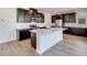 Gourmet kitchen with a large island, stainless steel appliances, and dark wood cabinets at 1320 Crimson Sunbird Ave, North Las Vegas, NV 89084