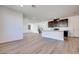 Open floor plan with wood look floors leading into a modern kitchen at 1320 Crimson Sunbird Ave, North Las Vegas, NV 89084