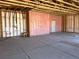 Spacious garage with unfinished framework, insulation, and concrete floor perfect for customization and storage at 1831 E Deerskin St, Pahrump, NV 89048