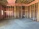 Living room with stud framing and insulation awaiting your personal touches, ready for customization at 1831 E Deerskin St, Pahrump, NV 89048