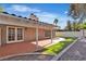 Backyard featuring manicured landscaping, artificial turf, brick patio and walkways, and covered patio at 2108 Plaza Del Dios, Las Vegas, NV 89102