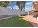 Backyard featuring manicured landscaping, artificial turf, and a covered patio at 2108 Plaza Del Dios, Las Vegas, NV 89102