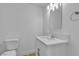 Bathroom featuring a new toilet, vanity with sink, mirror and overhead lighting at 2108 Plaza Del Dios, Las Vegas, NV 89102