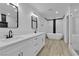 Modern bathroom featuring dual sinks, a soaking tub, a glass-enclosed shower and updated fixtures at 2108 Plaza Del Dios, Las Vegas, NV 89102