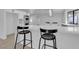 Open-concept kitchen featuring white countertops, stainless steel appliances and a breakfast bar at 2108 Plaza Del Dios, Las Vegas, NV 89102