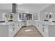 Bright kitchen with stainless steel appliances, white cabinets, and a large breakfast bar with seating at 2108 Plaza Del Dios, Las Vegas, NV 89102