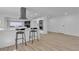 Modern kitchen with a breakfast bar, stainless steel appliances, and light wood flooring at 2108 Plaza Del Dios, Las Vegas, NV 89102