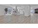 Open concept kitchen with stainless appliances, modern lighting, and wood flooring at 2108 Plaza Del Dios, Las Vegas, NV 89102