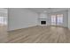 Living room with a stone fireplace and French doors leading to the outside at 2108 Plaza Del Dios, Las Vegas, NV 89102