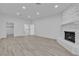 Large living room with a white painted stone fireplace and light wood-look floors at 2108 Plaza Del Dios, Las Vegas, NV 89102