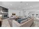 Spacious living room with a gray brick fireplace, neutral furnishings and open floor plan to kitchen at 2108 Plaza Del Dios, Las Vegas, NV 89102