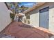 Side walkway with tiled surface and landscaped with mature plants and rocks at 2108 Plaza Del Dios, Las Vegas, NV 89102