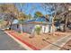 Charming single-story condo with blue tile roof and mature trees surrounding the property, creating a peaceful setting at 2110 Bavington Dr # C, Las Vegas, NV 89108