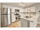 Modern kitchen with white cabinets, stainless steel appliances, and a sink with a sleek faucet set into the countertop at 2110 Bavington Dr # C, Las Vegas, NV 89108