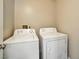 Laundry room featuring a white washing machine and a matching white dryer ready for convenient in-home laundry at 2110 Bavington Dr # C, Las Vegas, NV 89108