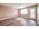 Bright living room featuring modern vinyl plank flooring and a door to the patio at 2110 Bavington Dr # C, Las Vegas, NV 89108