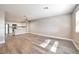 Open concept living space with stainless steel appliances and modern vinyl flooring at 2110 Bavington Dr # C, Las Vegas, NV 89108