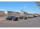 Exterior view of the building's parking lot with several cars parked under shade structures on a clear sunny day at 2110 Bavington Dr # C, Las Vegas, NV 89108