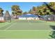 Outdoor tennis court surrounded by trees and fencing, showcasing a community recreational amenity at 2110 Bavington Dr # C, Las Vegas, NV 89108