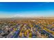 Aerial view of a neighborhood with a mountain range on the horizon under a clear blue sky at 2204 Ambermill Ct, Henderson, NV 89052