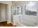 Bathroom featuring a soaking tub, a shower with glass doors, and a window to enjoy the outdoor view at 2204 Ambermill Ct, Henderson, NV 89052