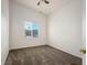 Cozy bedroom with neutral carpet, ceiling fan, and a window offering ample natural light at 2204 Ambermill Ct, Henderson, NV 89052