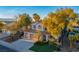 Two-story home with a well-manicured lawn, three-car garage and mature trees at 2204 Ambermill Ct, Henderson, NV 89052