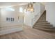 Elegant foyer with a grand staircase, chandelier, and views of the front entrance at 2204 Ambermill Ct, Henderson, NV 89052