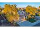 Aerial view of a two-story home with three-car garage, mature trees, and manicured landscaping at 2204 Ambermill Ct, Henderson, NV 89052