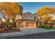 Charming two-story home featuring a three-car garage, well-manicured lawn, and mature trees at 2204 Ambermill Ct, Henderson, NV 89052