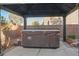 Covered hot tub with a privacy surround offering a relaxing outdoor experience at 2204 Ambermill Ct, Henderson, NV 89052