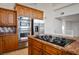 Close-up of kitchen with gas cooktop, stainless steel appliances, and warm wood cabinets at 2204 Ambermill Ct, Henderson, NV 89052
